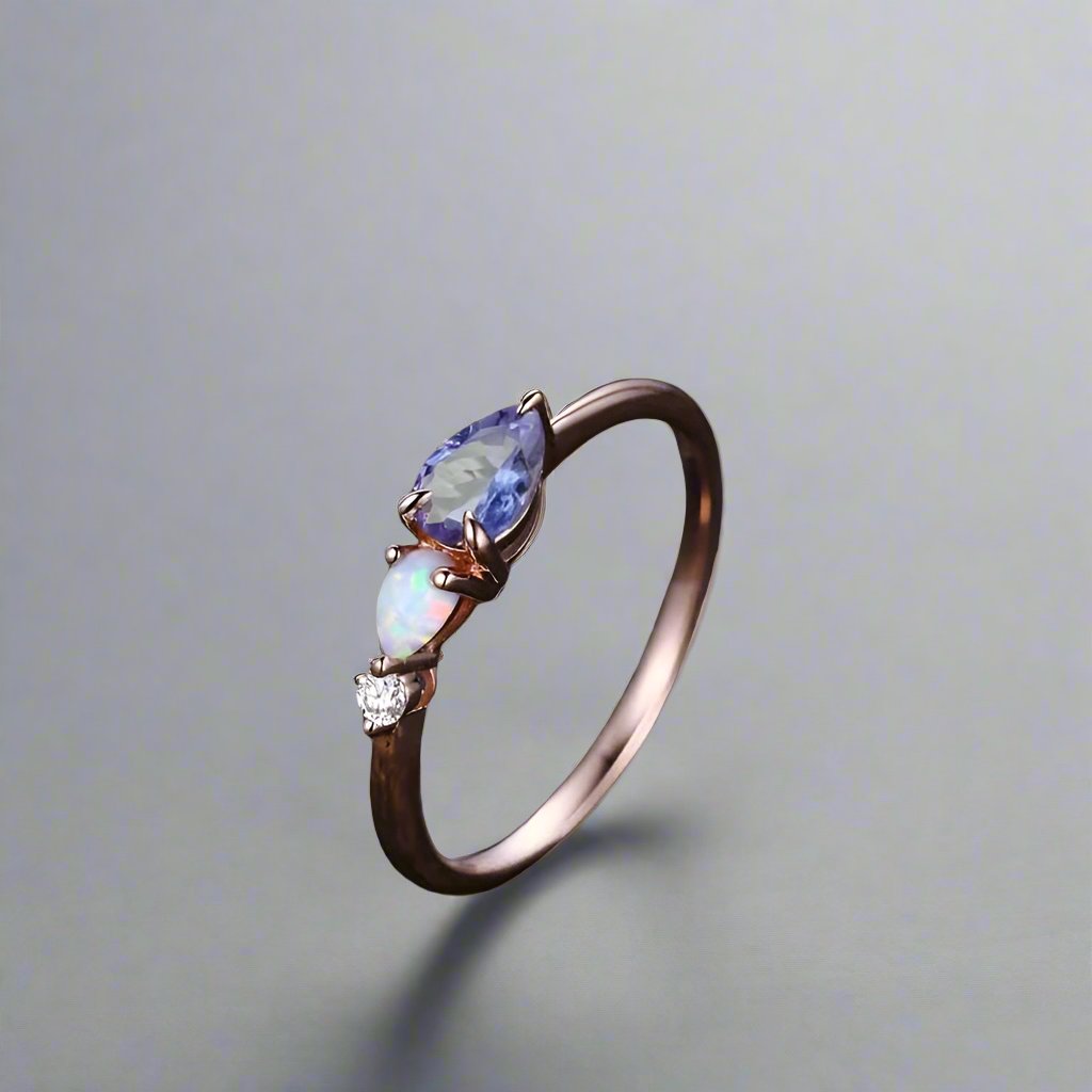 Ring adorned with a Tanzanite opal and white opal, set in rose gold, enhanced by ta moissanite. 