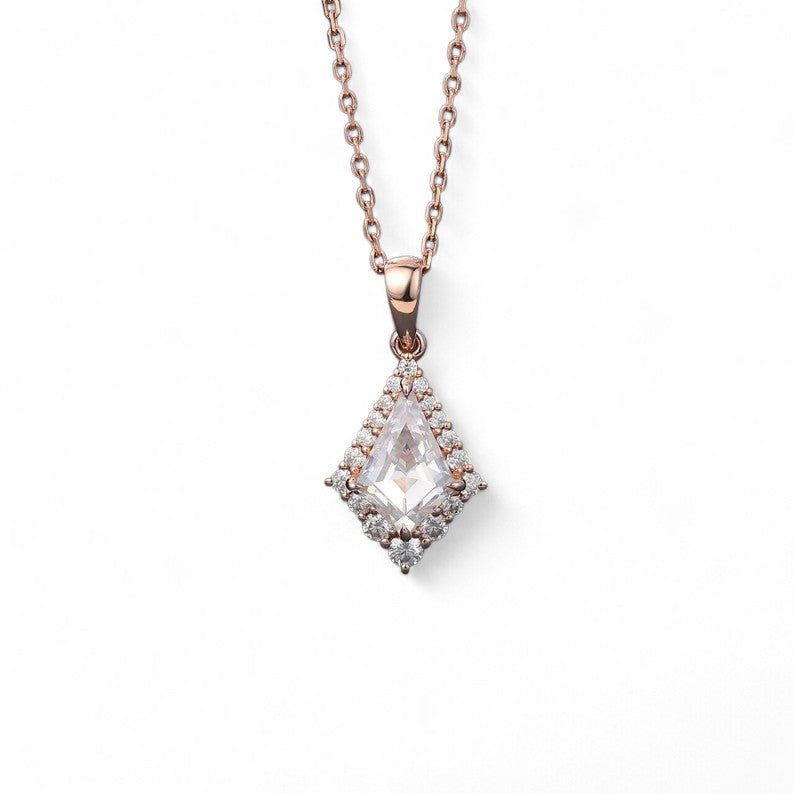 &quot;Delta Halo pendant with a 6x9mm kite-shaped lab-grown diamond center stone, framed by a halo of smaller lab-grown diamonds. The pendant combines geometric elegance with sustainable luxury for a captivating, modern look.&quot;