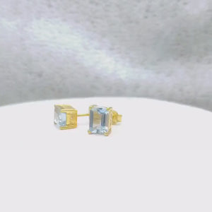 "Elegant emerald-cut gemstone stud earrings, titled 'The Lighthouse Studs,' featuring an 8x6mm gemstone with a minimalist, radiant design. Set with secure push backs, these studs capture timeless beauty and subtle brilliance for everyday wear or special occasions."